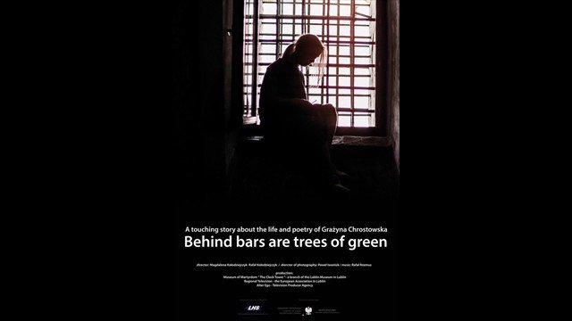 Behind bars are trees of green